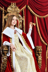 Portrait of beautiful princess with crown holding hand bell