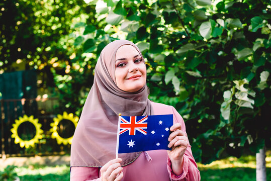 Muslim woman in hijab holds flag of Australia