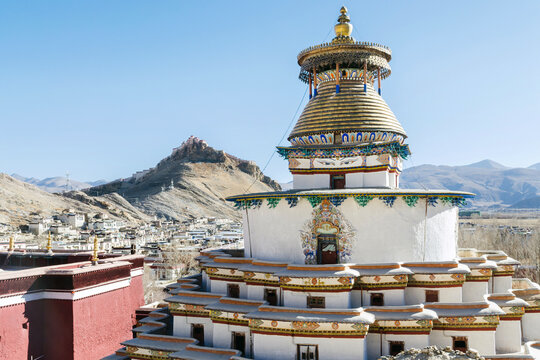 Gyantse Kumbum in Pelkor Chode or Palcho monastery with Gyantse Dzong or fort in the background, Tibet