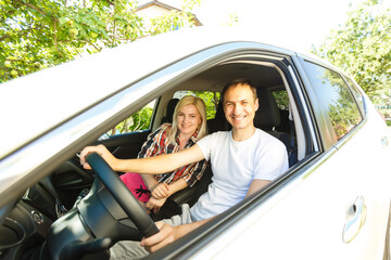 Young couple sitting in car