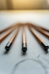 Fototapeta premium How to draw. The artist worskspace with pencils on the white paper, art, craft, creativity, inspiration, concepts