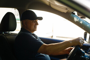 Smiling happy elderly senior man in the new car