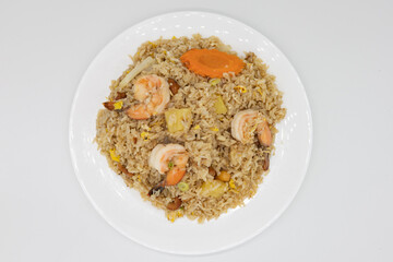 Above View of Thai Fried Rice with Shrimp and Pineapple on a White Plate