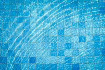Swimming pool background with sun reflect wave on surface.