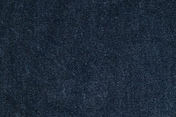 Texture details of dark blue jeans. Close up textile for background.