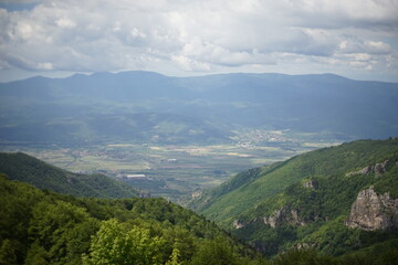 Naklejka na ściany i meble A panoramic view from the summit of Stara Planina (Balkan Mountains) towards the valleys in the south of Bulgaria.