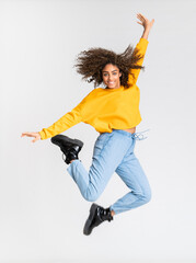 Young African American woman dancing over isolated white background