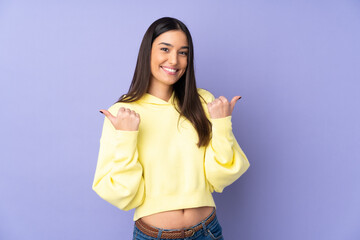 Fototapeta na wymiar Young caucasian woman over isolated background with thumbs up gesture and smiling