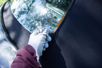 repair of the tarpaulin roof of the convertible, sew up the material with threads.