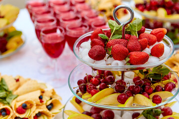 Close-up plate with berries, strawberries. raspberries, cherries, blueberries, and baked goods. Buffet table at the festival. Catering concept