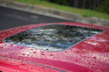 Raindrops on a red car