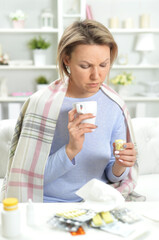 Portrait of beautiful young woman taking pills