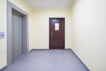 Elevator and entrance doors inside of the apartment building.