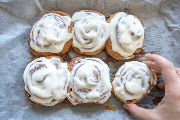 fresh baked homemade cinnamon rolls glazed with classic cream cheese, traditional cinnabons home baking
