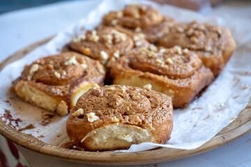 fresh baked homemade cinnamon rolls glazed with caramel and nuts, traditional cinnabons home baking