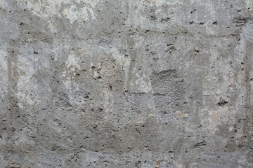 Old, crumbling concrete surface that requires plastering and repair. Background image of the texture
