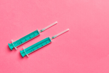 Top view of medical syringes on colorful background with copy space. Injection equipment concept