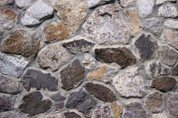 Stone wall, texture. Granite stones of different sizes, masonry. Background