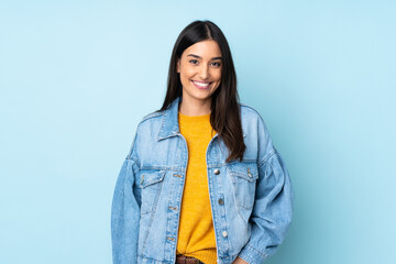 Young caucasian woman isolated on blue background laughing