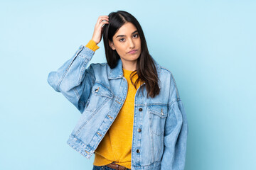 Young caucasian woman isolated on blue background with an expression of frustration and not...