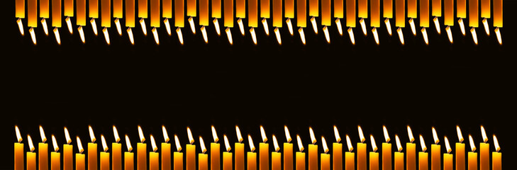 Wax candles burning in darkness. Long banner with copy space