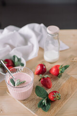 Yogurt with fresh strawberries on wooden table. Homemade healthy dessert.