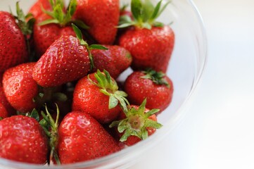 Summer vitamin fruits in a bowl. Strawberry close up background with copy space 