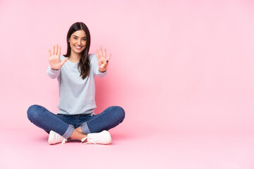 Young caucasian woman isolated on pink background counting nine with fingers