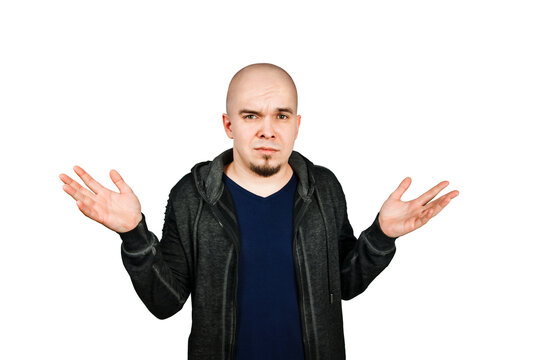 Confused young bald man with alopecia shrugs, isolated on white background