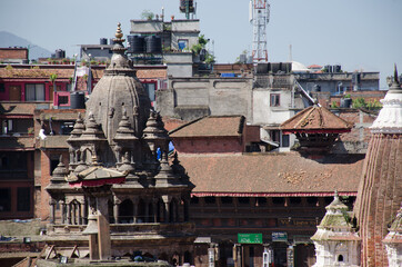 Perspective of Patan Durbar Square Unesco World heritage site in Kathmandu, Nepal, with tile rooftops and ancient stone temples and stupas