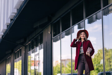 Fototapeta premium young elegant fashionable business woman wearing trendy coat nea