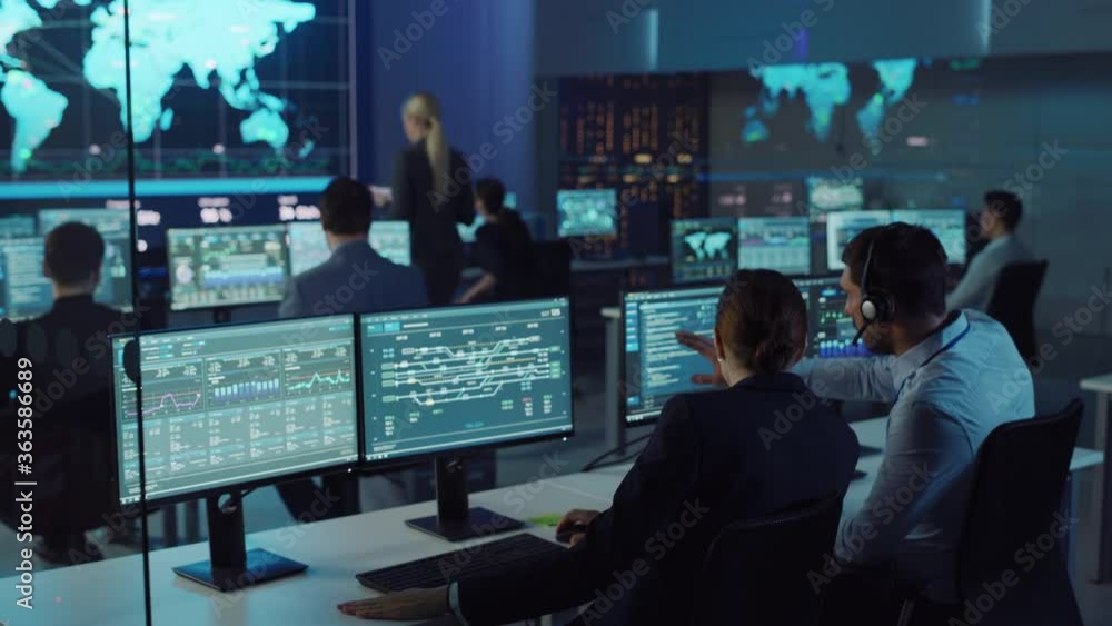 Leinwandbilder Team of Professional Computer Data Science Engineers Work on Desktops with Screens Showing Charts, Graphs, Infographics, Technical Business Data and Statistics. Low Key Control and Monitoring Room.