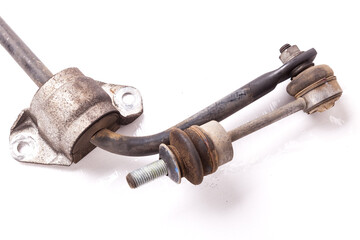 Close-up metal stabilizer rack on a white background in a second-hand photo studio with rust for replacement during repair or for sale at an auto-parsing.