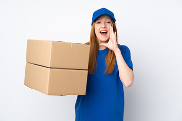 Young delivery woman over isolated white background shouting with mouth wide open