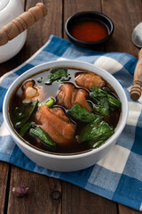 stewed pork leg in bowl on wood