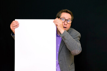 Front view image of caucasian Business man holding a blank banner isolated on black background