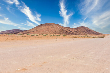 Fototapeta na wymiar Gravel road and beautiful landscape in Namibia