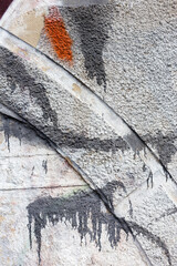 Hooligan smeared paint the walls of the old building. Landscape style. Grungy concrete surface with...