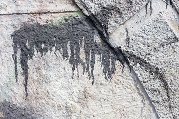 Hooligan smeared paint the walls of the old building. Landscape style. Grungy concrete surface with...