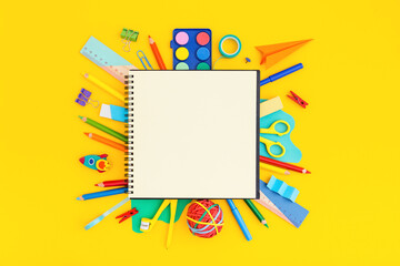 School notebook with school supplies on grid background. Back to school. Elementary school concept.	
 - obrazy, fototapety, plakaty