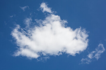 Fluffy white cloud in a blue sky, template for design