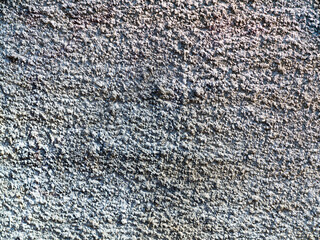 Hooligan smeared paint the walls of the old building. Landscape style. Grungy concrete surface with cracks, scratches and streaks of paint. Great background or texture.