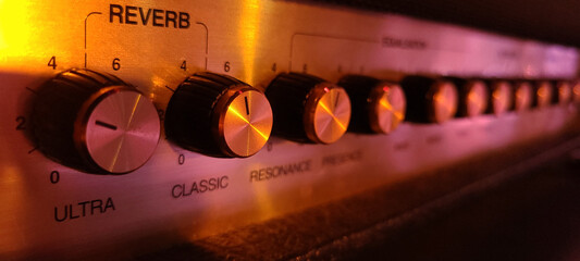 Guitar amplifier closeup, focus on knob