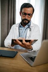 consultation of a doctor on tablet and computer