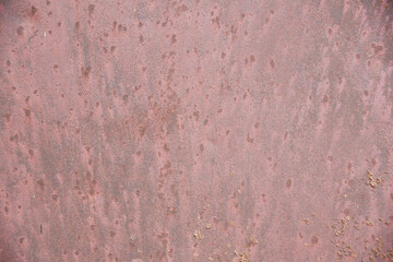 Close-up background of an old metal sheet of pink color.