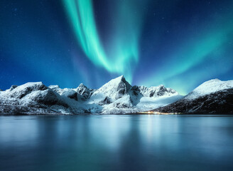 Aurora Borealis, Lofoten islands, Norway. Northen lights, mountains and reflection on the water....