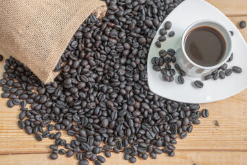 Black coffee in white cup and coffee beans