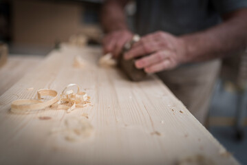Fototapeta na wymiar man work on a table, wood work, handmade work, traditional italian artisan