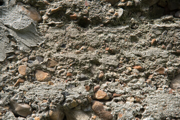 Closeup background of a cement foundation with small stones, gravel.