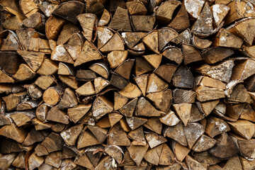 firewood stacked at woodpile. Wood background and texture.